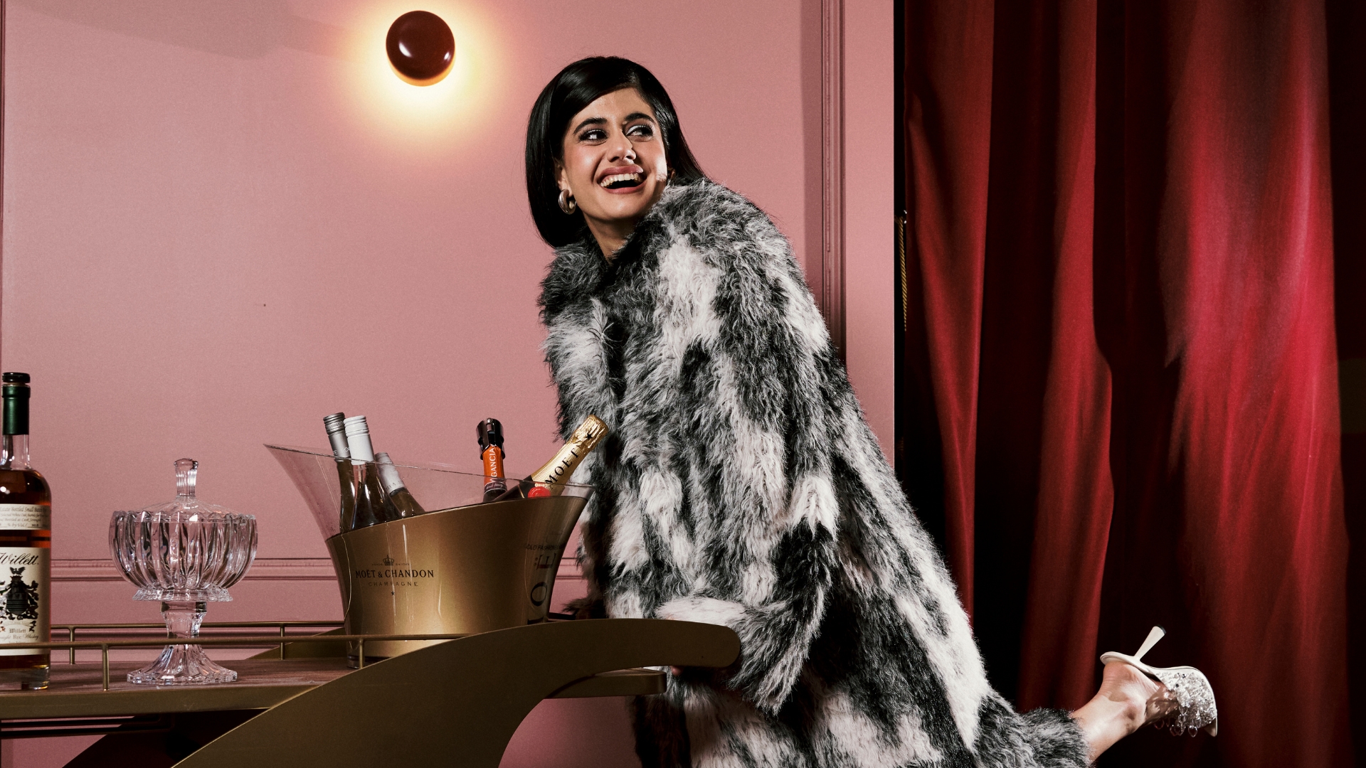 ayesha madon wearing a black and white fur coat