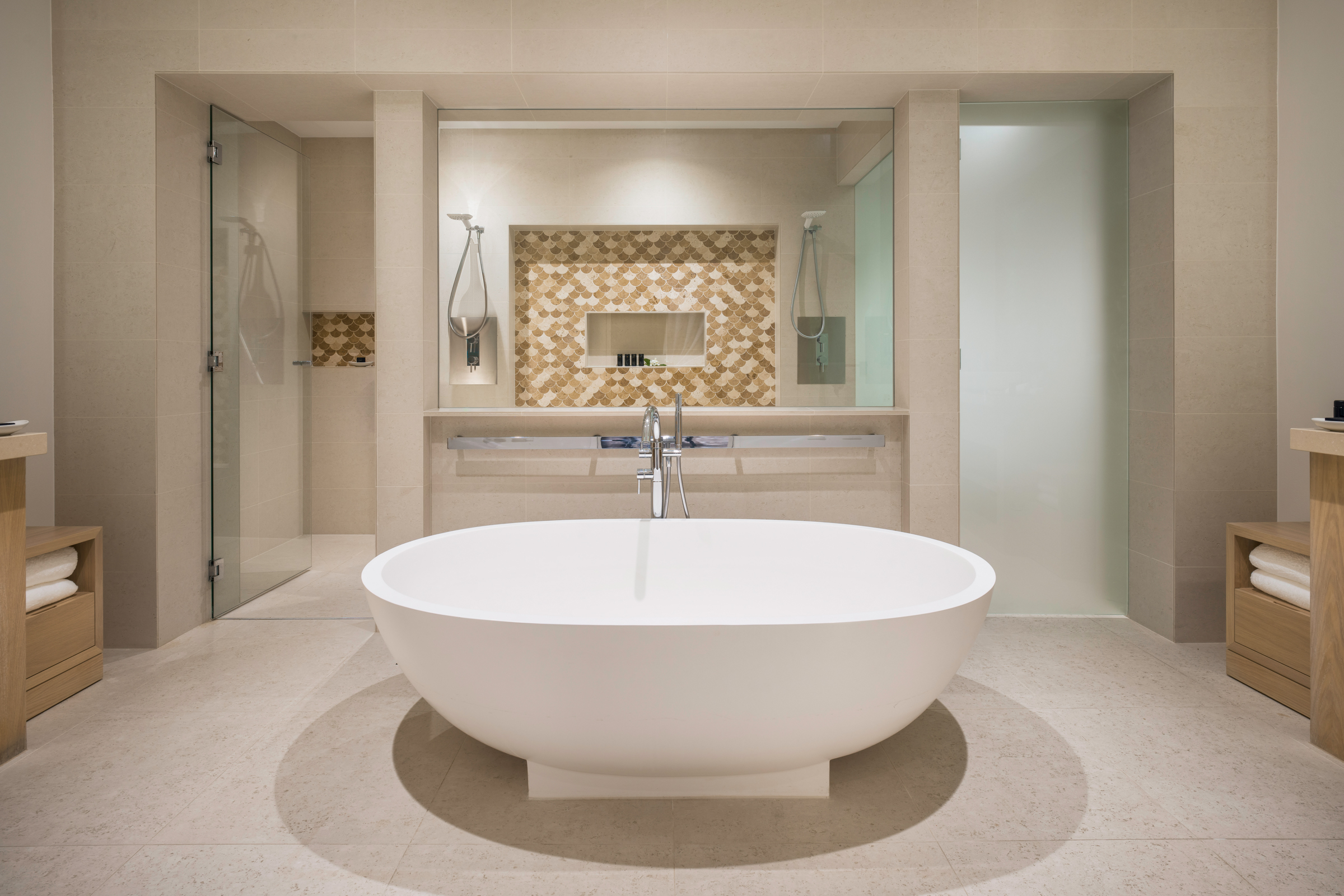 a large white bathtub in a bathroom
